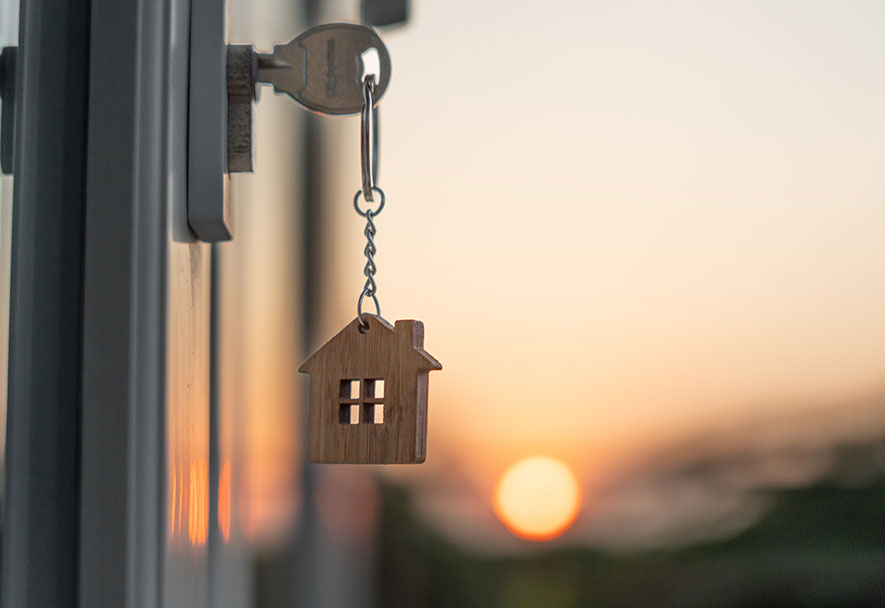 a key in a door lock with house on it