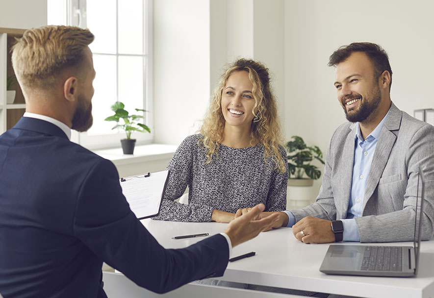 Saker Realty Happy Couple Getting Service Assistance Image
